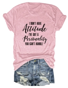 Detail of pink cotton T-shirt featuring 'I DON'T HAVE Attitude' typography design