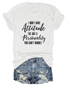 Close-up of white graphic T-shirt with personality quote and distressed denim shorts