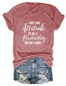 Flat lay of a red graphic tee with white lettering and distressed denim shorts set