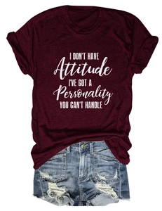 Detail view of burgundy cotton T-shirt with slogan print and distressed denim shorts