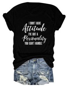 Detailed flat lay of a black slogan t-shirt paired with distressed blue denim shorts