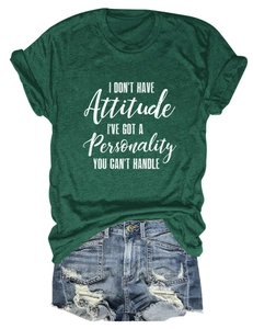 Close-up of dark green t-shirt with white slogan print and ripped denim shorts