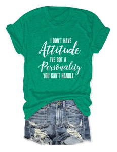 Green t-shirt with slogan print paired with distressed denim shorts on white background