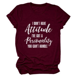 Detail view of burgundy cotton T-shirt featuring white slogan print and rolled sleeve cuffs