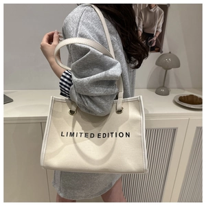 Lifestyle view of cream canvas tote bag with Limited Edition print and leather piping