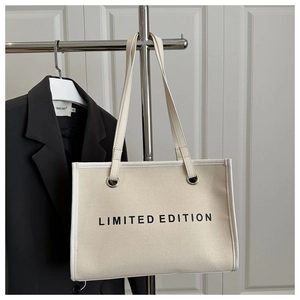 Detail of canvas tote bag with LIMITED EDITION print and reinforced shoulder strap