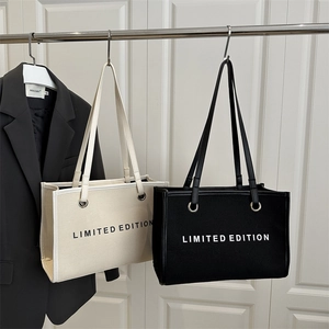 Minimalist canvas tote bag with Limited Edition print and faux leather trim straps