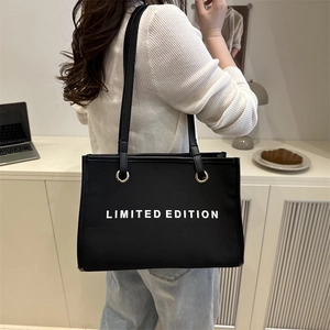 Black canvas tote bag with Limited Edition print, spacious shoulder bag for commuting