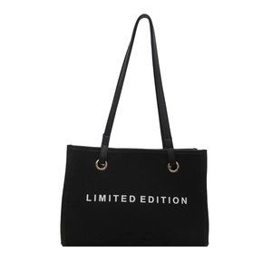 Large black canvas tote bag with white LIMITED EDITION print and golden metal eyelets
