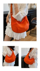 Detail of orange nylon dumpling bag showing braided side ropes and adjustable wide strap