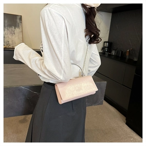 Détail du sac bandoulière rose en cuir PU avec chaîne et poignée ronde en métal