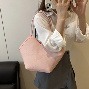 Pink woven straw tote bag for beach vacations featuring a unique V-cut top and slim straps