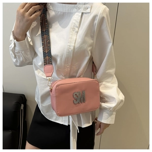 Pink crossbody bag featuring SM logo and ethnic style wide geometric woven strap