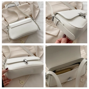 Detail view of white PU leather underarm bag featuring silver lock and interior storage