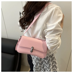Detailed view of pink faux leather shoulder bag with elegant silver metallic buckle closure