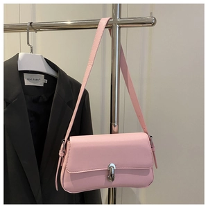 Detailed view of pink leather underarm bag featuring a metallic U-shaped silver buckle