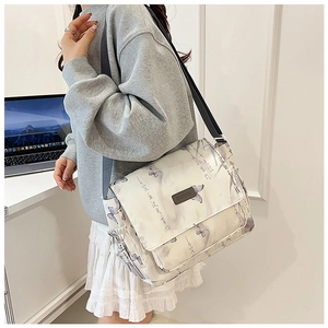 White butterfly messenger bag detail with purple artistic prints and adjustable strap