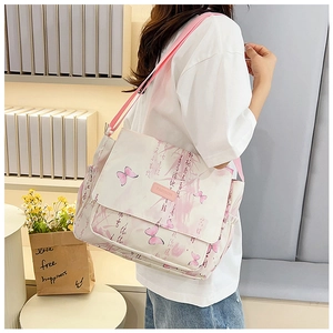 Detail view of pink butterfly print canvas crossbody bag with adjustable shoulder strap