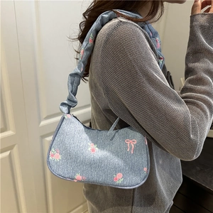 Blue denim shoulder bag with pink floral patterns and ruched strap for women