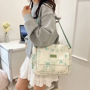 Minimalist beige canvas crossbody bag with green butterfly print and adjustable strap