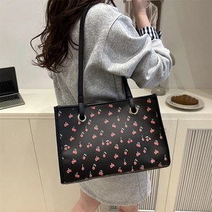 Floral cherry print black tote bag shown on model for daily work and commuting style