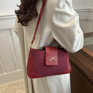 Minimalist burgundy crossbody bag with suede patchwork and golden bow buckle detail