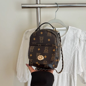 Mini brown leather backpack with bear print, gold hardware, and metal chain straps