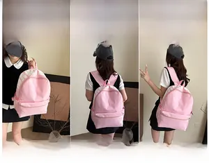 Pink minimalist backpack detail showing versatile straps for hand and shoulder carrying