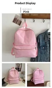 Pink minimalist backpack featuring top letter printing and side mesh pockets detail