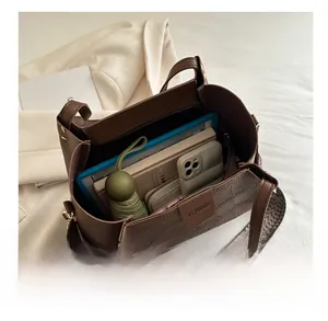 Detail of coffee tote bag with croc pattern, spacious interior, and woven strap