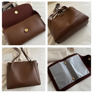Detail view of brown crocodile-embossed tote with woven strap and card holder insert