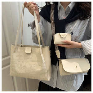 Detailed close-up of three-piece crocodile pattern tote bag set in creamy white PU leather