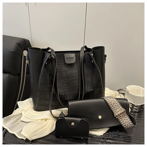 Detailed view of crocodile pattern tote bag set with ethnic strap and gold hardware