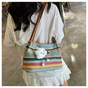 Detail of colorful striped woven bucket bag with leather straps and cute cloud charm