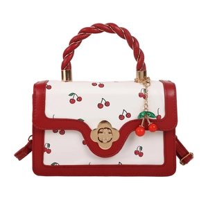 Mini sac à main avec imprimé cerises rouges et fermoir fleur dorée sur blanc