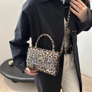 Leopard print PU leather shoulder bag with gold bow ornament and adjustable strap