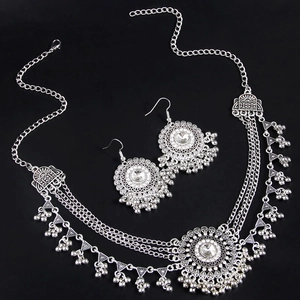 Silver bohemian jewelry set featuring a floral forehead chain and matching dangle earrings