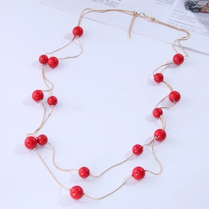 Double-layered gold chain necklace with polished red beads and adjustable clasp