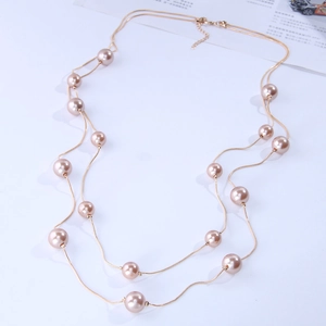 Elegant double-layer necklace featuring golden snake chains and champagne pearls on white base