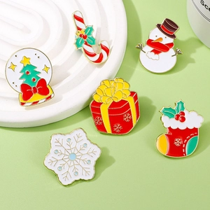 Christmas enamel pin set featuring snowman, tree, and snowflake on a green festive background