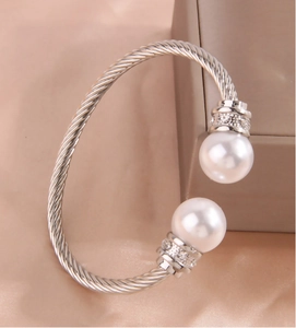 Detail of silver cable bangle with faux pearls and sparkling rhinestones on silk