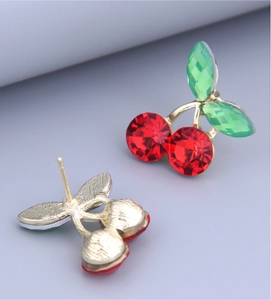 Detail view of cherry stud earrings showing front crystal side and back needle structure