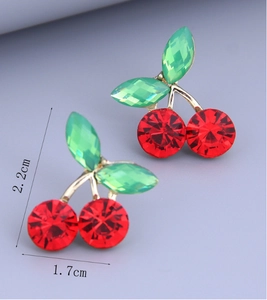 Macro detail of cherry stud earrings with 2.2cm height and 1.7cm width dimensions