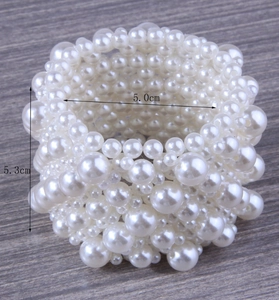 Detail showing the 5.3cm width and 5.0cm diameter of the wide pearl stretch bracelet