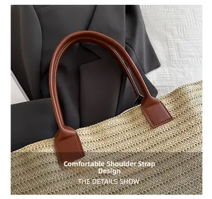 Detail showing the comfortable brown leather handle attached to the woven straw tote bag