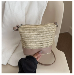 Detail of hand-woven straw crossbody bag featuring premium PU leather base and zip closure