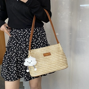 Minimalist straw bucket bag with brown leather straps and cute cloud charm pendant