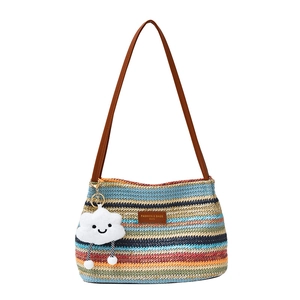 Colorful striped woven shoulder bag with brown leather strap and cloud charm on white background