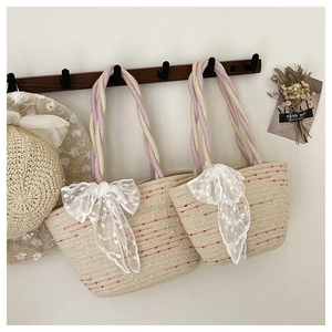 Detailed view of woven straw bucket bags with lace bows and matching summer hat set