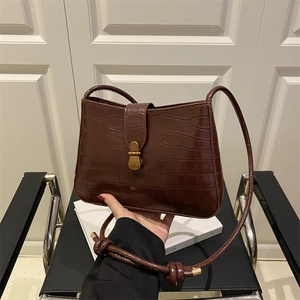 Vintage dark brown faux crocodile leather shoulder bag with bronze metal clasp and knotted strap